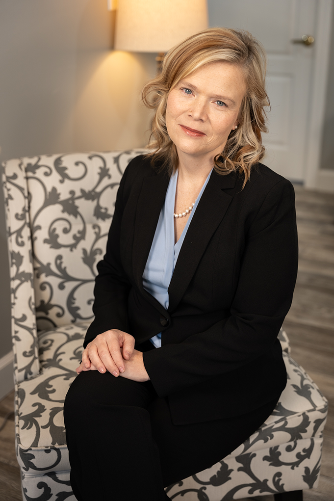 Karen Robins Kacey Carnegie sitting in a chair and tilting her head to the right