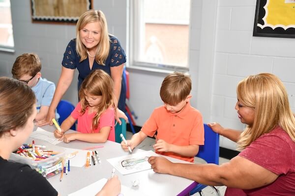 Kacey Carnegie working with school children at a table